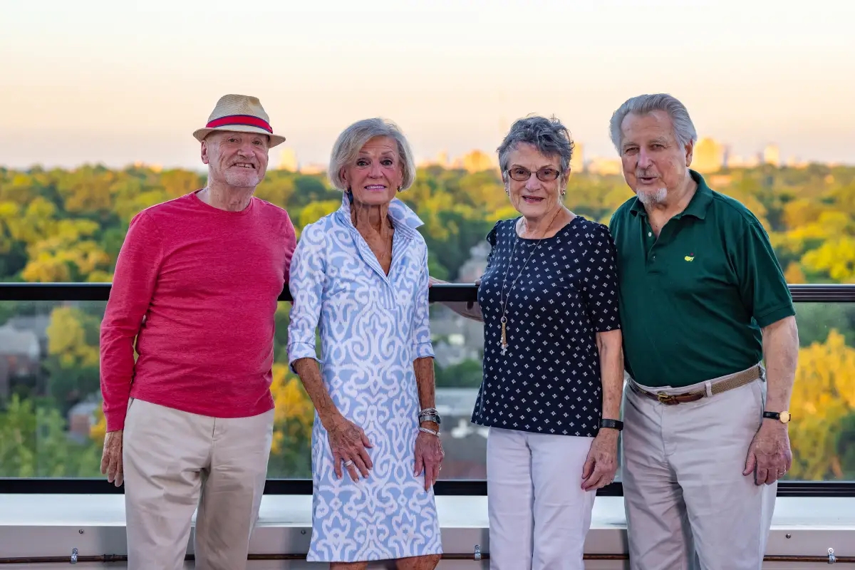 A group of Clarendale Clayton residents posing for a picture outside during sunset