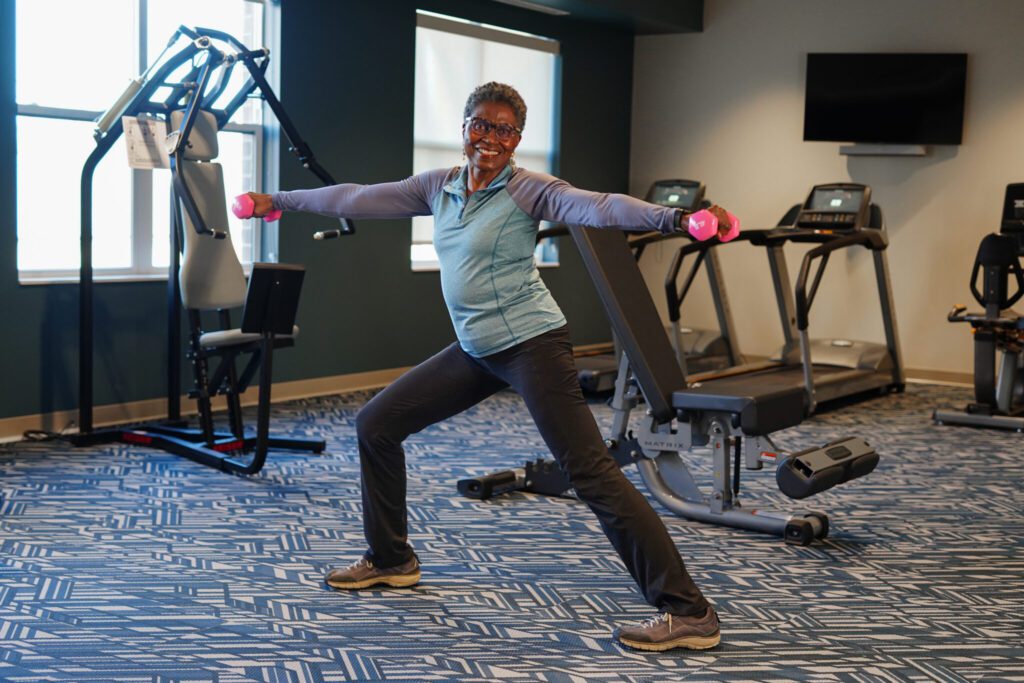 Senior woman at Clarendale Clayton working out with freeweights