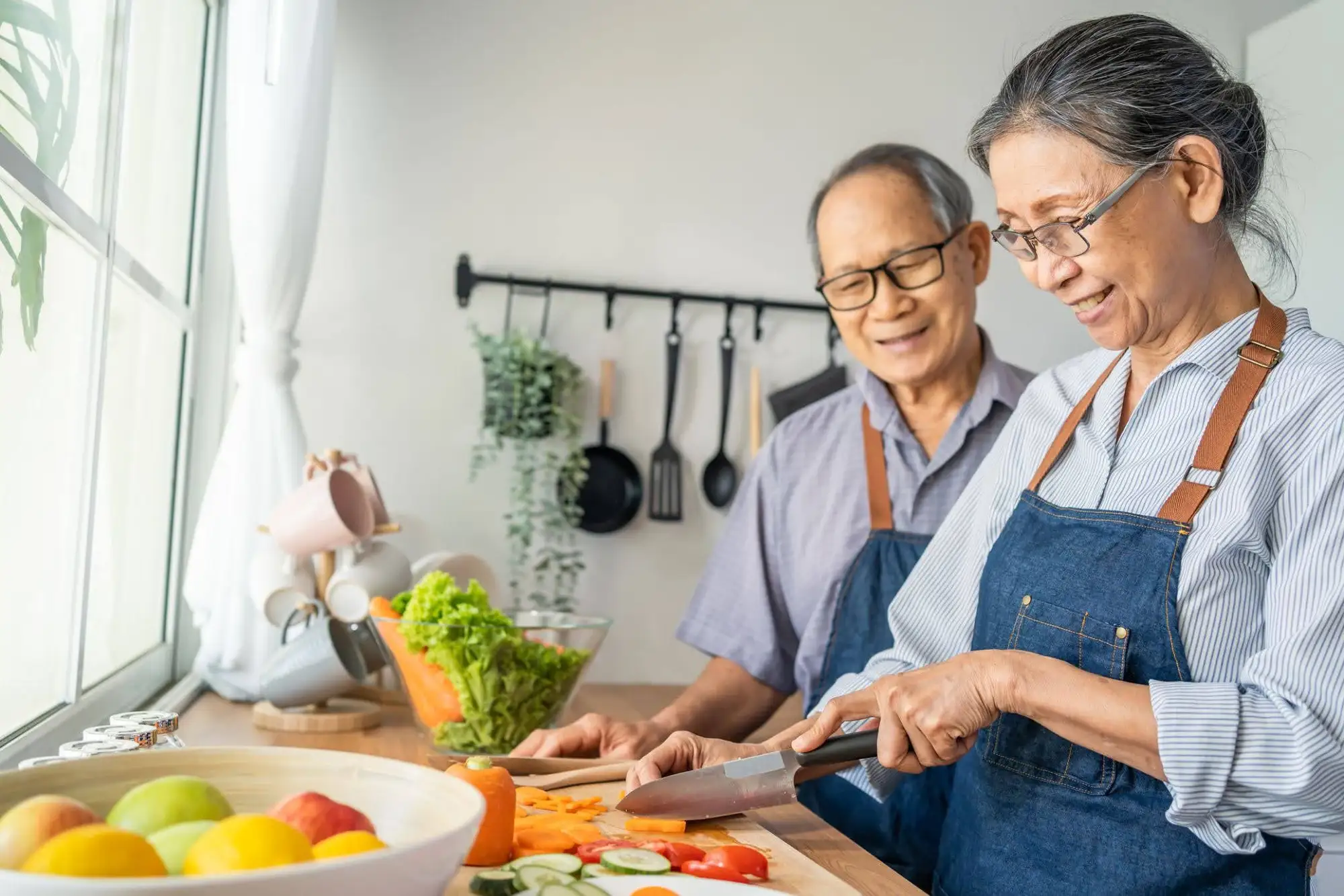 Residents of Clarendale Clayton making brain-healthy foods for seniors to focus on senior nutrition from their independent living apartment in Clayton, MO.